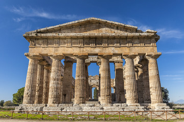 Front view of greek temple of Neptune, in the archaeological site of Paestum, Salerno, Italy
