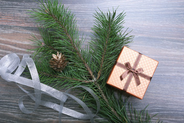 Gift box with christmas tree on wood background
