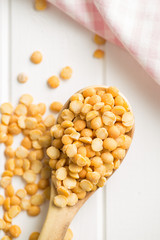 Yellow split peas in wooden bowl.