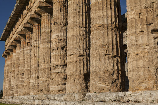 Close up of columns of greek temple of Neptune, in the archaeological site of Paestum, Salerno, Italy