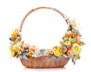 Fototapeta na wymiar basket decorated with fruit and flowers on a white background