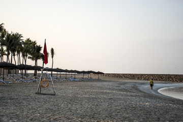 Flag no swimming danger sign at beach souly bay salalah Oman