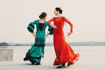Two dancers flamenco in traditional Spanish dress - obrazy, fototapety, plakaty