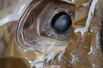 dent on a brown car body near petrol cap