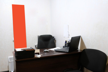 Interior of an office room with chair, table and stationery on it