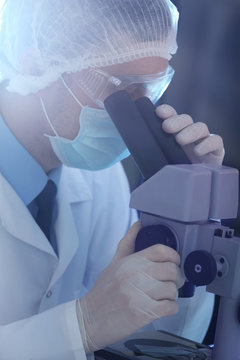 Young male scientist making experiments in laboratory