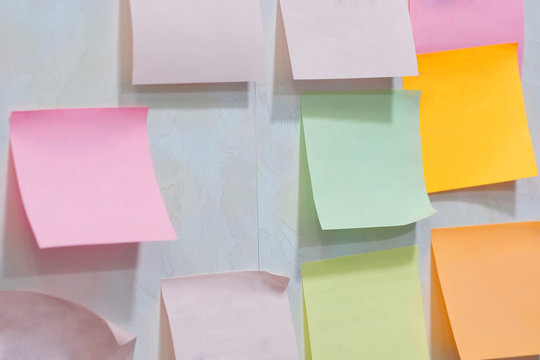 sheets for the notes hang on a wall at office