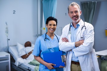 Portrait of smiling doctor and nurse in ward