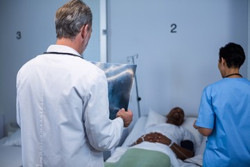 Doctor analyzing x-ray in ward