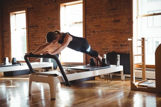 Woman practicing pilates on reformer