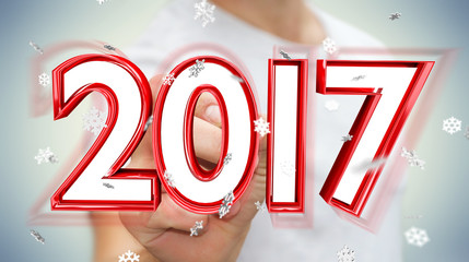 Businessman touching 2017 3D rendering text