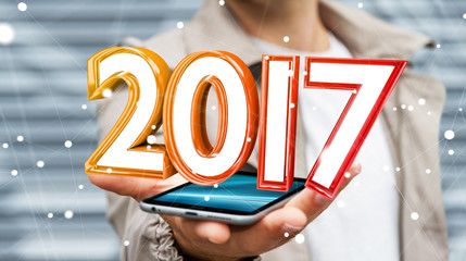 Businessman holding 2017 3D rendering text