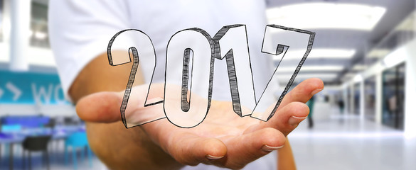 Businessman holding 2017 hand drawn text