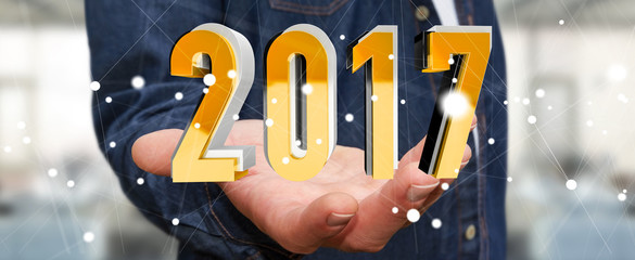 Businessman holding 2017 3D rendering text