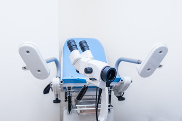 Close up colposcope on the background of gynecological chair