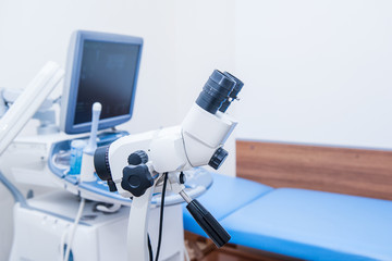 Close up colposcope on the background of ultrasound machine in gynecological room