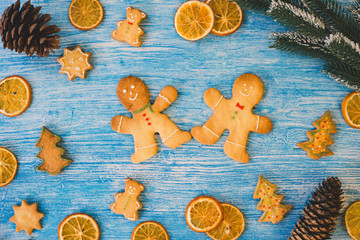 Christmas gingerbread cookies and christmas decorations on blue wooden background. Winter holidays concept