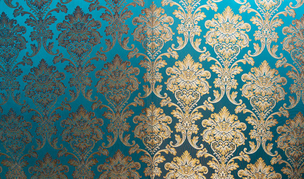 The texture of silk with a floral pattern. Chinese silk brocade, beautiful expensive fabric background. Gold ornament turquoise embroidery on fabric