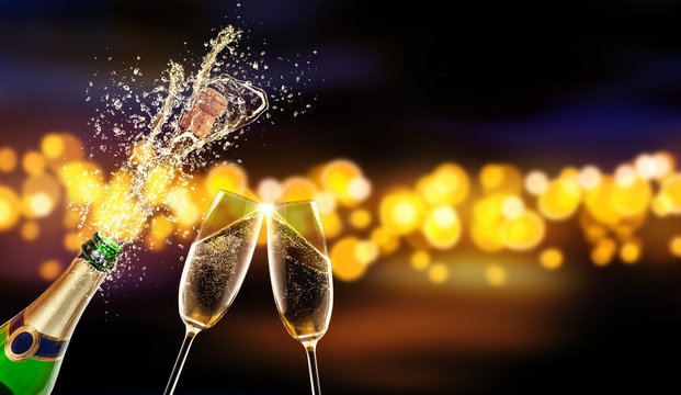 Bottle of champagne with glass over blur background