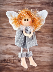 vintage toy angel figurine on wooden table