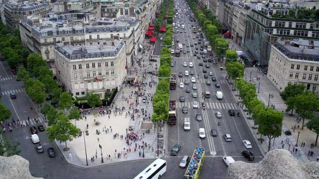 Traffic and people on Champs Elysee. Paris, France