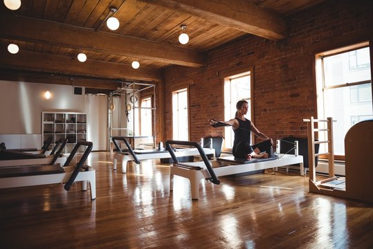 Woman practicing pilates in fitness studio