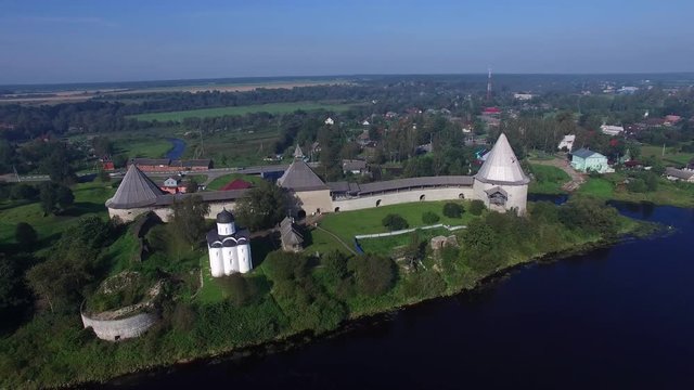 Flying over the vintage fortress in Staraya Ladoga on the banks of the river Volhov. Aerial view.
