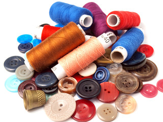 colorful spools of thread for sewing lie scattered on the buttons next to the breastplate is