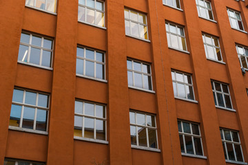 Fototapeta na wymiar orange office or finance building facade in low angle view