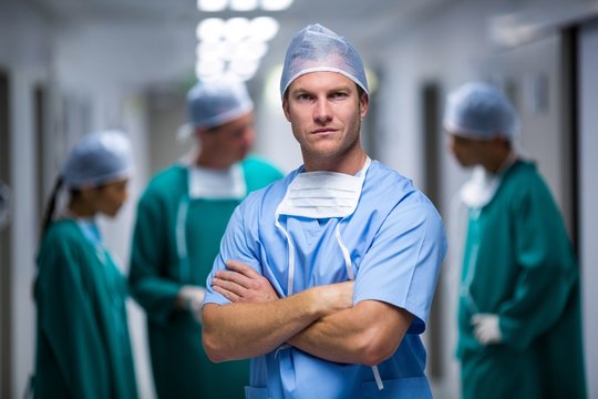 Portrait Of Male Nurse Standing In Corridor