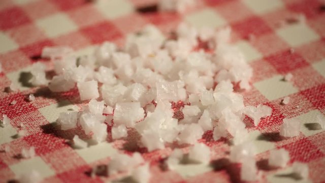 Droping Sea slat on a checkered kitchen table with red and white.