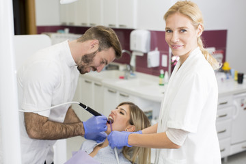 Young woman getting dental treatment in dentist office