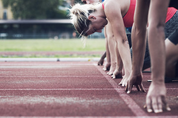 Runners poised at starting line on track