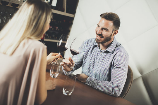 Handsome young couple on the date in wine bar