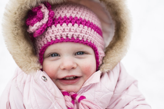 Portrait of cute smiling girl in warm clothing