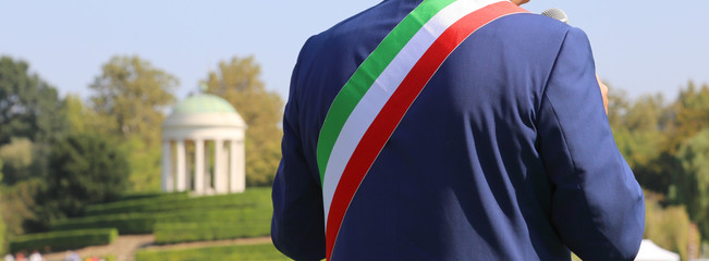 Italian mayor with the tricolor flag at a public event outdoors