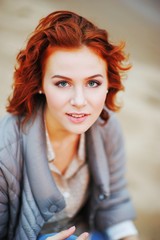 Wonderful portrait of charming girl with bright brown hair and beautiful eyes on blurred background, close up