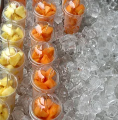 Selbstklebende Fototapeten fruit salad with pineapple and melon in the glasses © ChiccoDodiFC