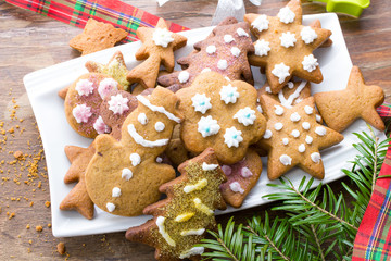 Colorful Christmas gingerbread cookies on wooden background