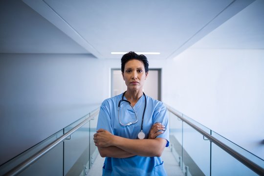 Portrait Of Female Nurse Standing In Corridor