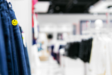 View of many denim jeans in the clothing store with smile sign. Concept  good purchases