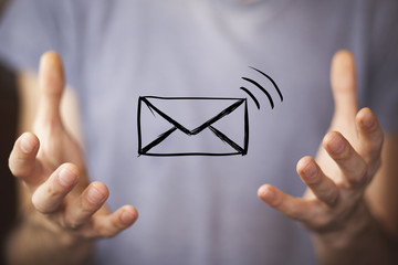 man holds a virtual postal envelope, concept of emai