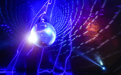 Disco ball laser show in modern disco party night club with bright spotlight - Concept of nightlife with music and entertainment - Image with powered colored halos and vivid glowing lights