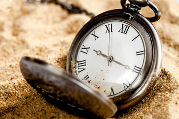 deadline concept pocket watch in sand background
