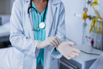 Doctor wearing gloves in hospital