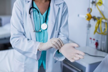 Doctor wearing gloves in hospital