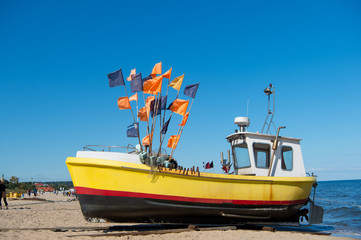 Yellow boat on sea beach