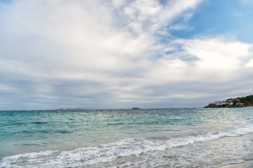 cloudy beach with wavy water