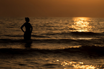 Silhouette Woman on the Sea Beach at Sunset