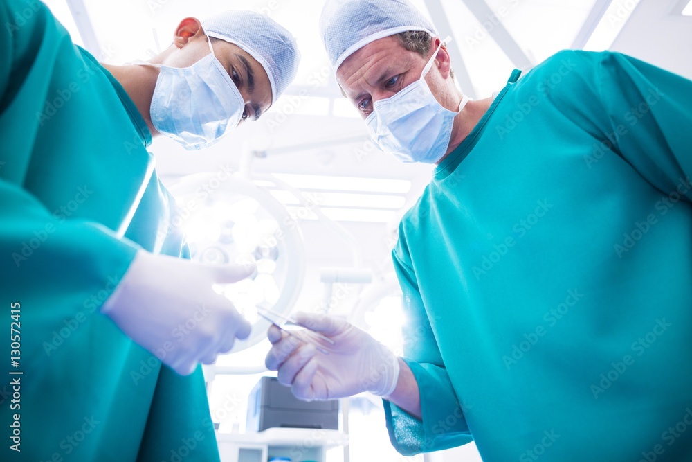 Poster surgeons performing operation in operation room